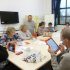 Group of members learning how to use ipads.