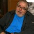 GDA Trustee, Alan Dick - Alan has short grey hair and a short grey beard, and is wearing glasses, a grey fleece and bright blue t-shirt.