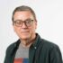 GDA Trustee Billy McFarlane - Billy has glasses and short dark hair, and is wearing a colourful t-shirt under a dark shirt.