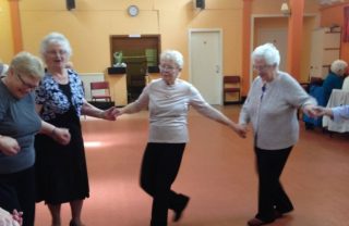 Members of GDA's star clubs dancing, hand in hand.