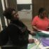 One member is laughing while taking part in a craft workshop