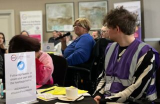 GDA member holds a mic at a GDA meeting