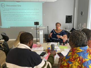 Paula speaks to a discussion group at a GDA event.